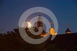 Moonset over old church