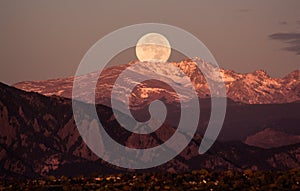 Moonset over the rocky mountains, behind Boulder Colorado photo