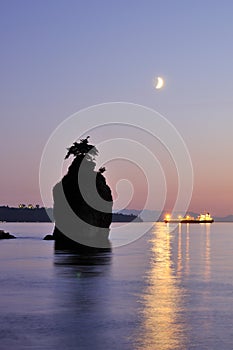 Moonset and siwash rock in Stanley Park photo
