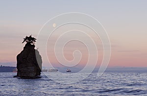 Moonset with siwash rock, stanley park photo