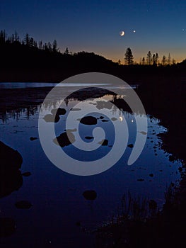 Moonset with Venus, reflected in lake