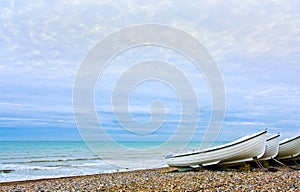 Rowing boats on Hove beach at sunset