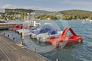 Moored boats along the waterfront of Velden village, Austria photo