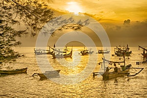 Moored boats during sunrise in Satelit Beach Banyuwangi photo