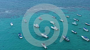 Moored boats swaying on the water surface. Stunning seascape with turquoise Caribbean Sea