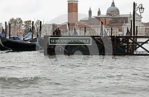 moored gondolas with the Italian text meaning Gondola Service photo