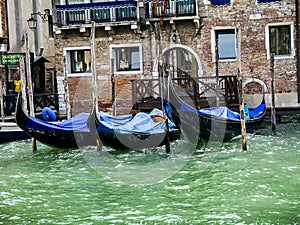Moored gondolas on a side canal in Venice Italy