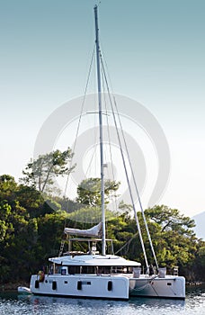 Moored in a lagoon catamaran. Rest on the sea, boat trip. photo
