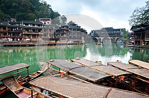 Moored rowing boats on the Tuojiang river, Fenghuang ancient town, China