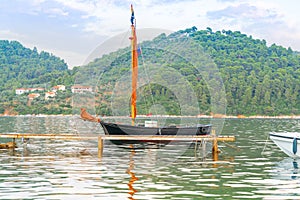 Moored sailer traditional style with wooden spar