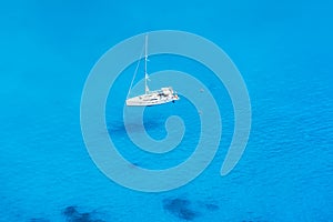 A sailing boat over the blue sea of the Ionian Islands in Greece, Zakynthos photo