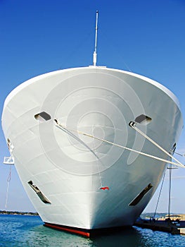 Moored ship, cruise ship bow, ship tied with ropes at the dock