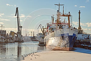 Moored ships and harbor cranes in port