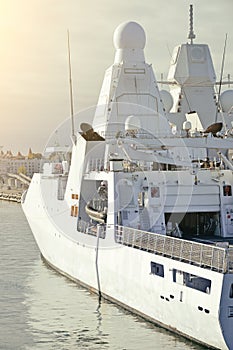 Moored white naval ship.