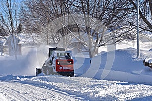 Bobcat Skid steer blows snow after a storm