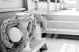 Mooring Bitts with white rope on the large ship, black and white photo
