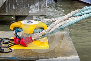 A mooring bollard entwined with mooring ropes