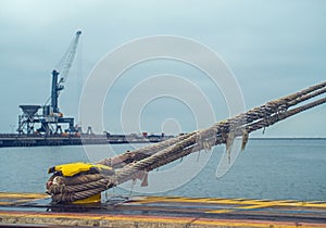 Mooring cleat and steel rope or hawser photo