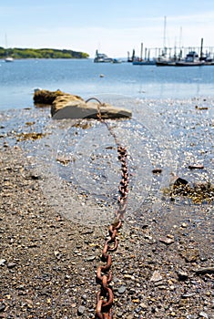 Mooring chain for boat leading to rock