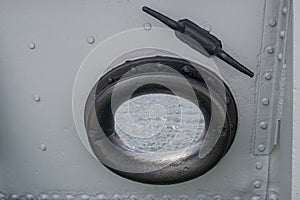 Mooring fairlead with round hole, black cast-iron ring with rounding on ship installed in riveted bulwark, above is casted horn.