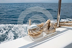 Mooring line on a white yacht in the sea