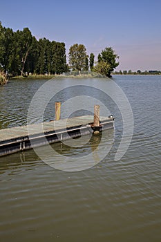 Mooring on a river with a shore that stretches on it in the background