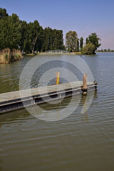 Mooring on a river with a shore that stretches on it in the background