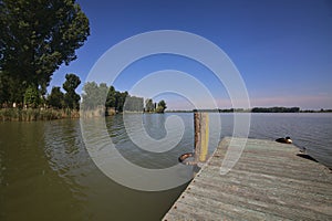 Mooring on a river with a shore that stretches on it in the background