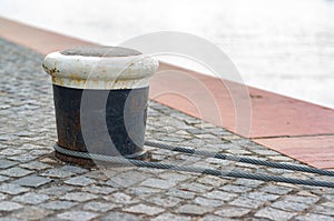 Mooring rope and bollard on lake against the river