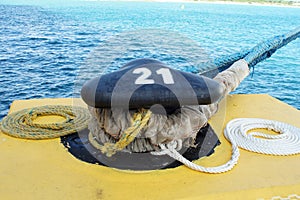 Mooring rope on a bollard on a pier