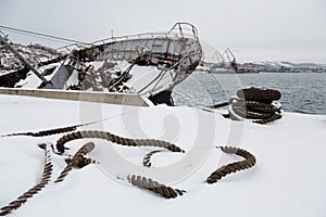 Mooring rope lies on a pier with sunken ship