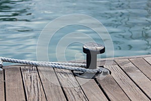 Mooring rope tied around steel anchor photo