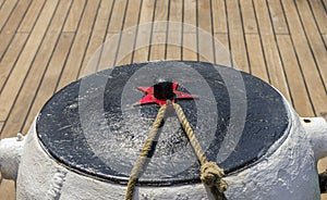 Mooring rope tied on the bollards of old wooden ship