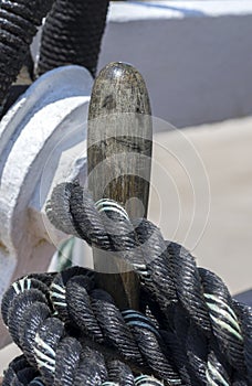 Mooring rope tied on the bollards of old wooden ship