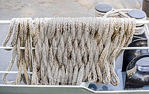 Mooring rope is wound around a metal deck guard of a ship