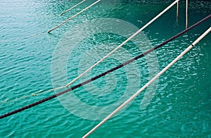 Mooring ropes against Mediterranean gree