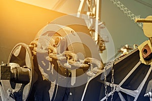 Mooring windlass and big anchor chain on station forward.