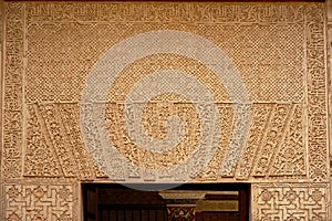 Moorish decorations with organic shapes above a door in Nasrid palalce, Alhambra, Granada