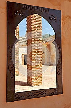 Moorish mirror in the courtyard of a farmhouse, optical effect of trompe l`oeil photo