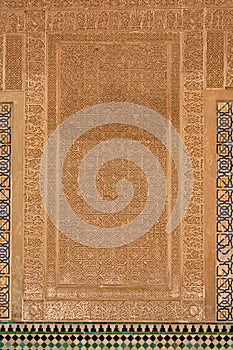 Moorish wall decorations with organic shapes and calligraphy on a wall in Nasrid palace, Alhambra, Granada