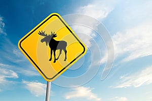 Moose road sign with blue sky and cloud background
