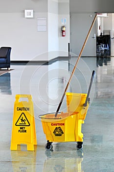 Mop and Bucket with Caution Sign photo