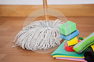 Mop and cleaning equipment on wooden floor