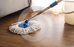 Mop cleaning on wooden floor photo