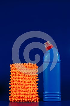 mop cloth and blue bottle with reading agent on blue background