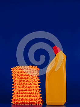 mop cloth and yellow bottle with reading agent on blue background