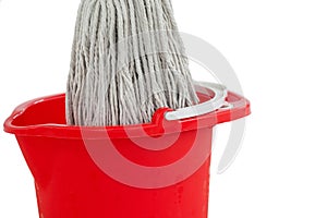 Mop in red bucket against white background