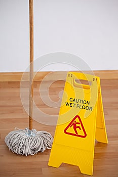 Mop with wet floor caution sign