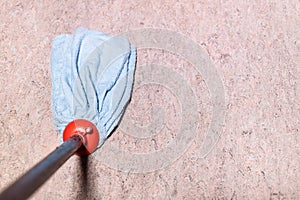 mop is wiping linoleum floor at home