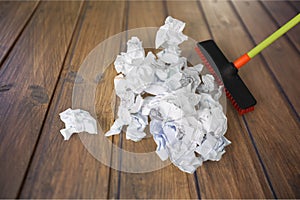 Mopping crumpled pile of papers on background